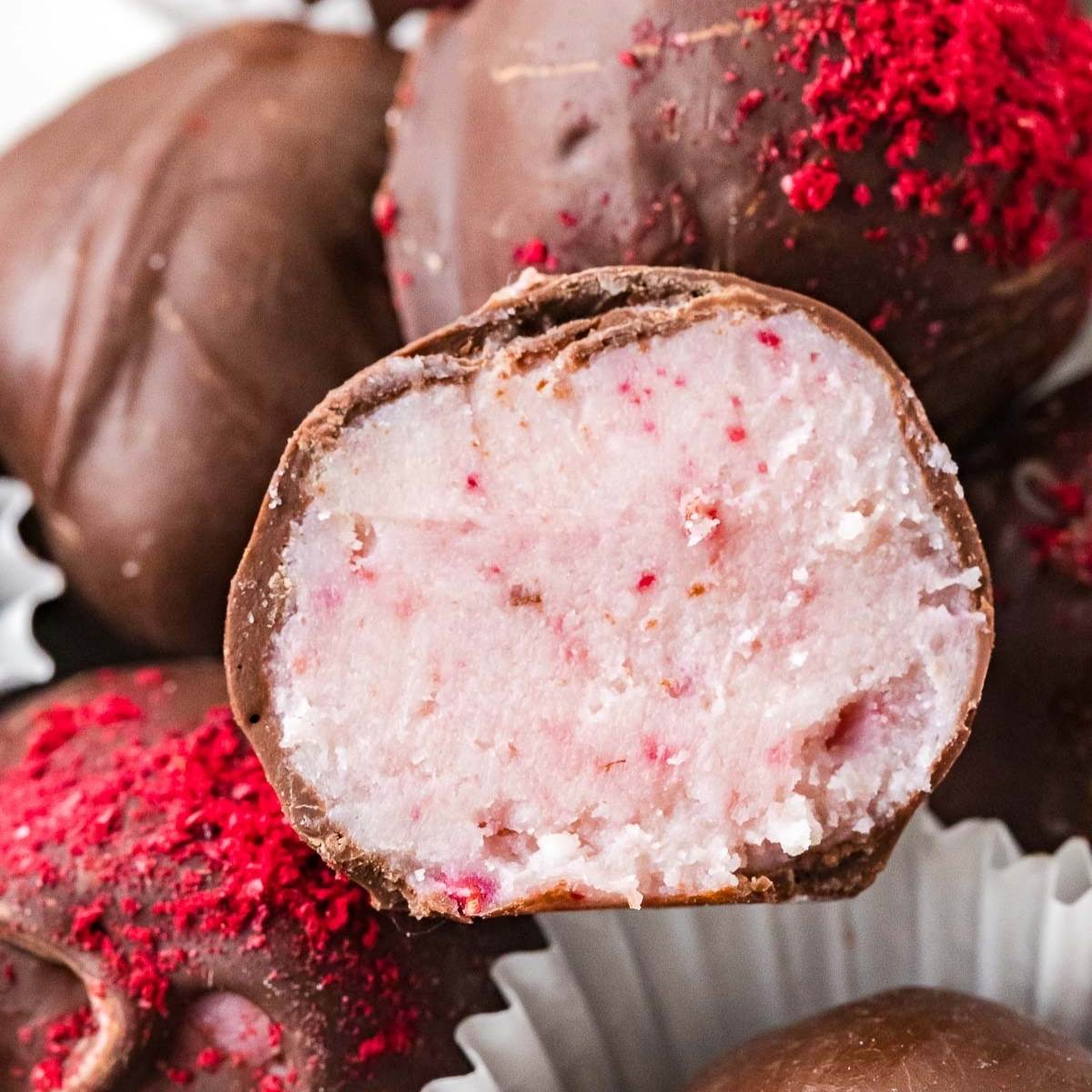 cut in half raspberry truffle coated in chocolate.