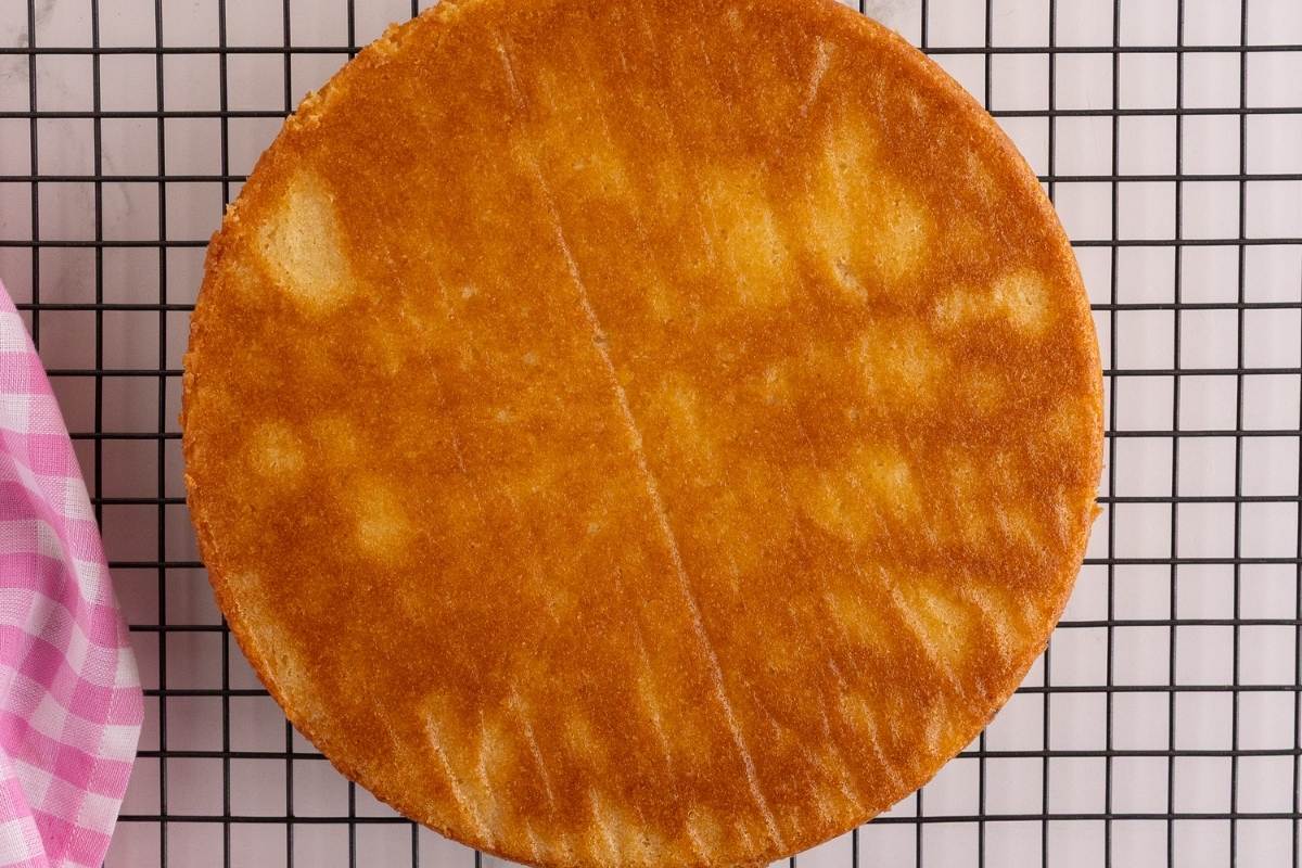 Round cake on cooling rack.