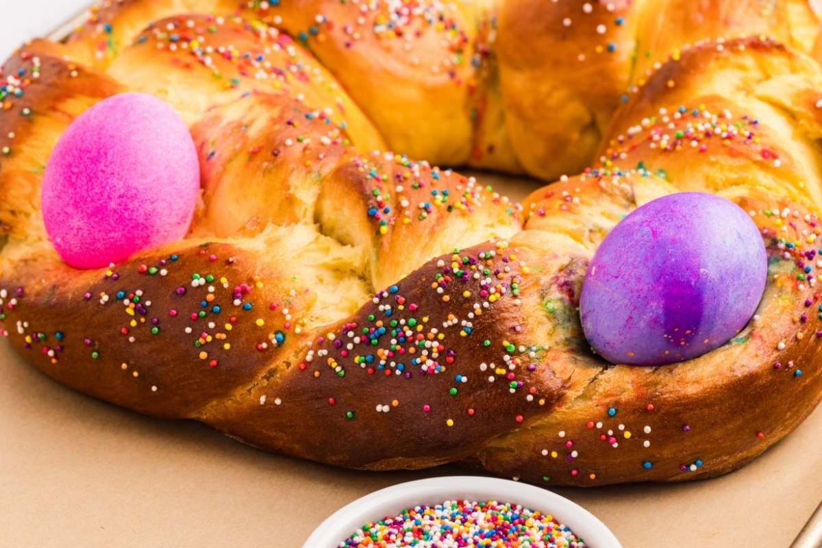  Golden braided Easter bread ring with pink and purple dyed eggs.