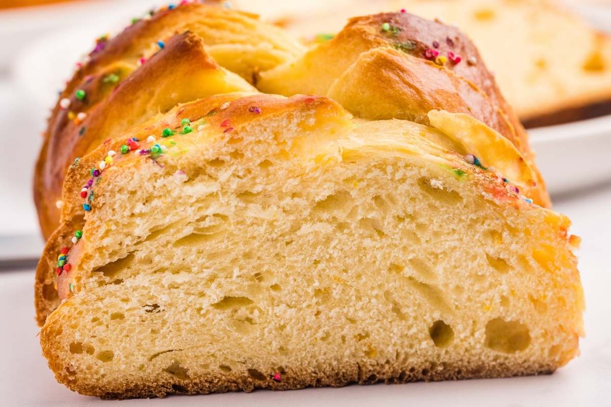 Close-up slice of Easter bread showing soft, fluffy interior texture.