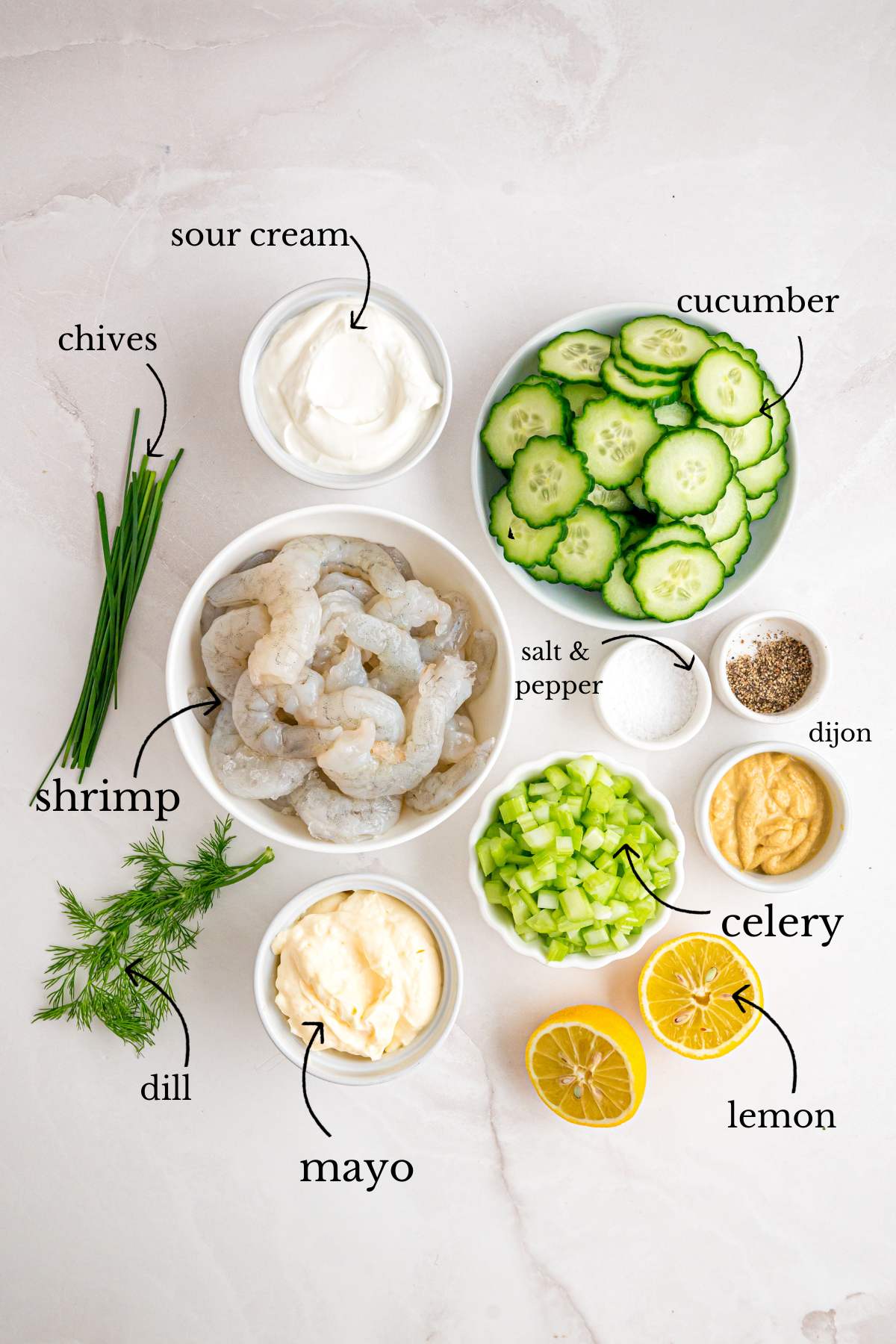 Raw ingredients for shrimp salad in individual bowls with text labels.