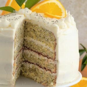 sliced layer cake with orange and poppyseed