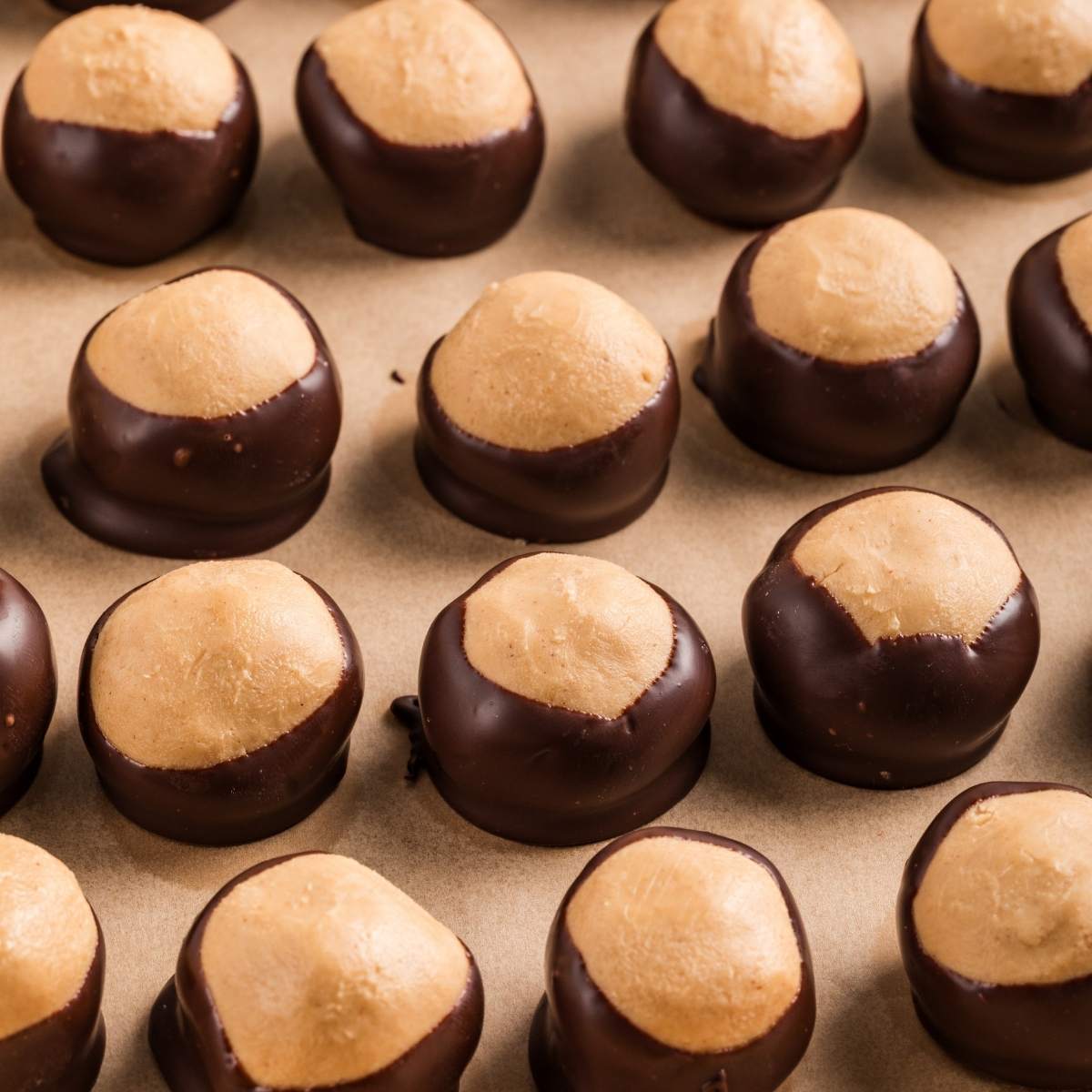 finished buckeye balls on parchment lined paper