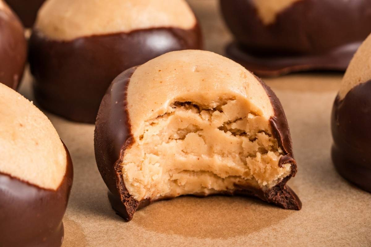 A buckeye ball broken open to show the peanut butter center.