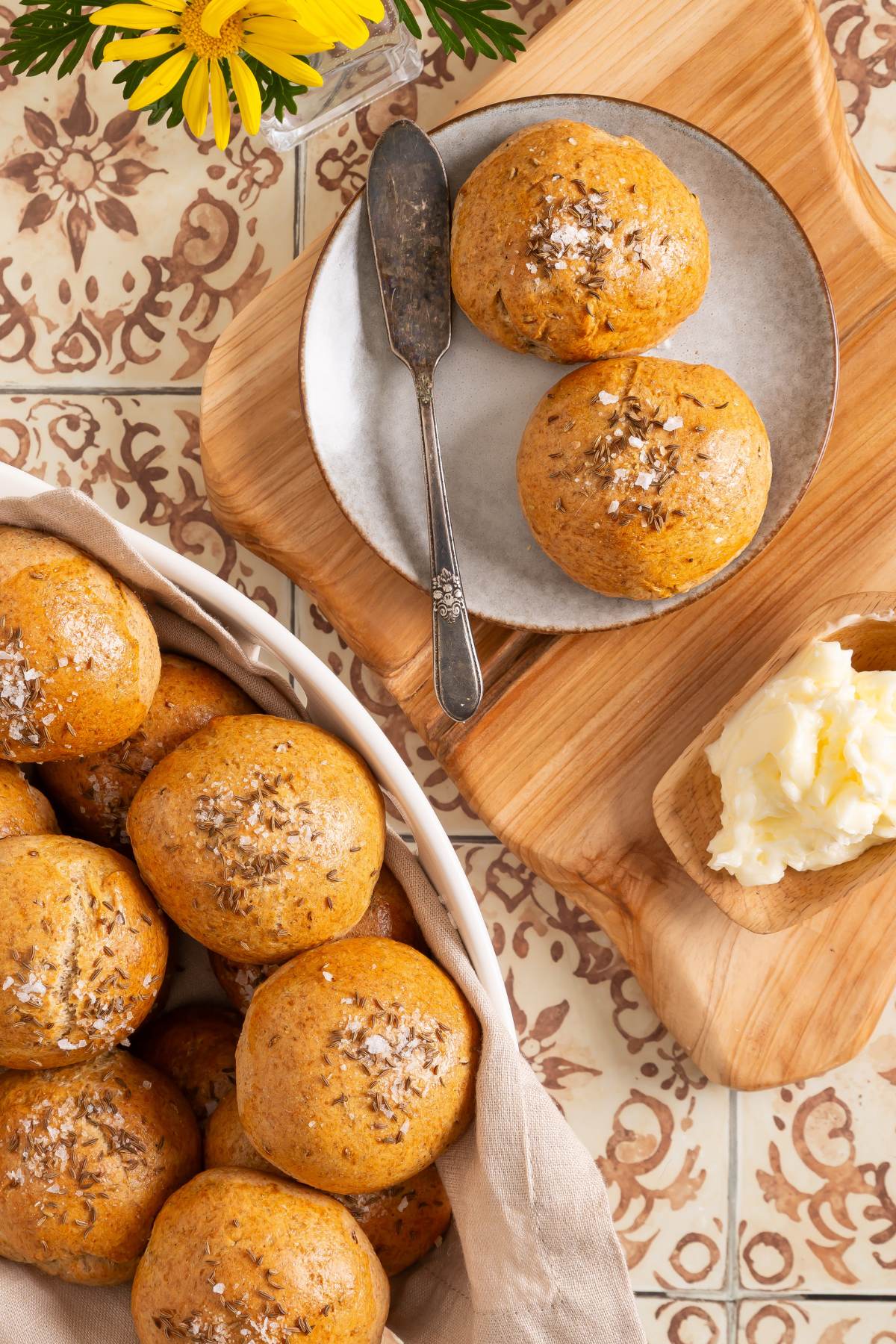 rye dinner rolls in dihs on tile counter.