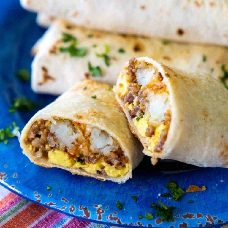 Breakfast burrito, cut in half, on blue plate 