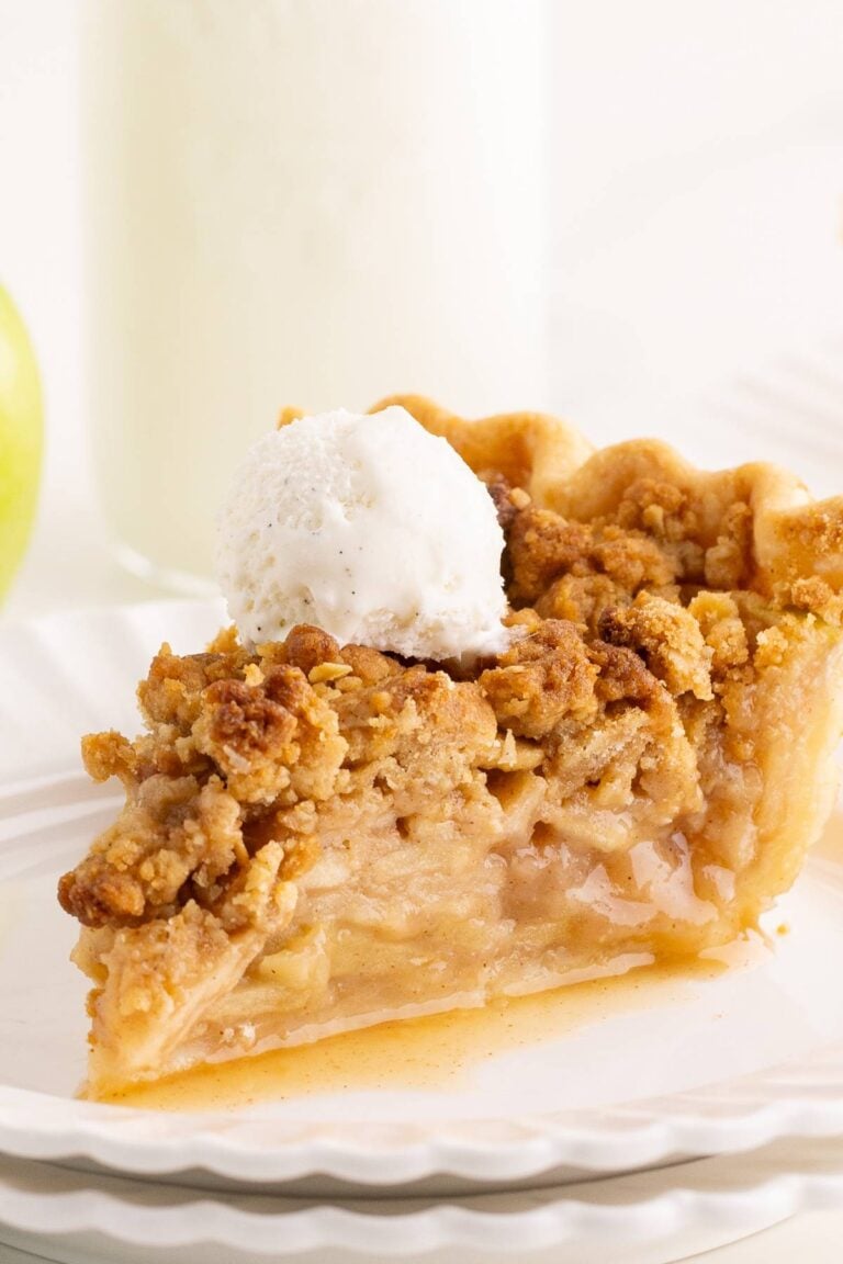 slice of apple pie on white plate.