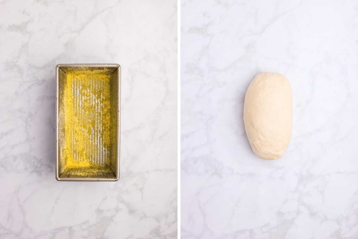 Loaf pan dusted with cornmeal beside a shaped oval of pale bread dough on marble.