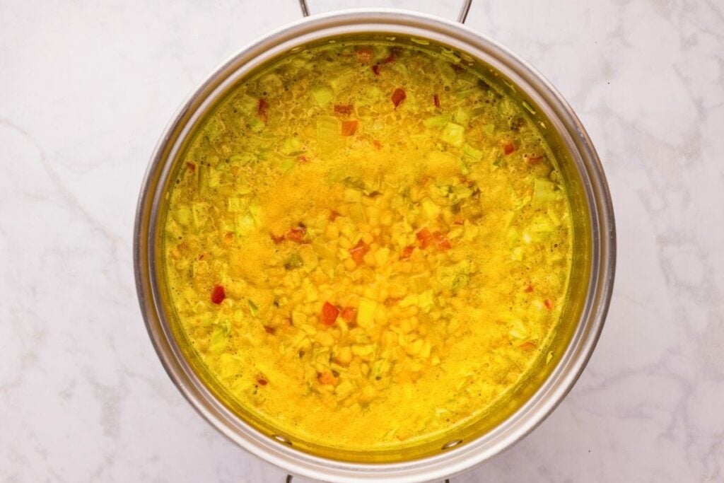 large pot with corn relish ingredients coming to a simmer