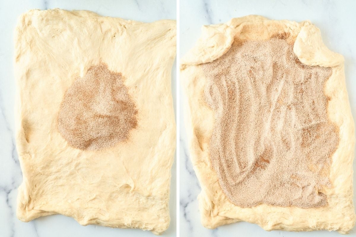 Cinnamon sugar filling piled in the center of rolled dough, then spread across the surface on marble.