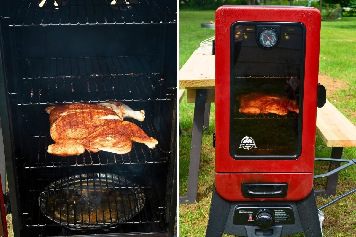 Seasoned whole chicken smoking on a rack inside a red Pit Boss vertical smoker outdoors.