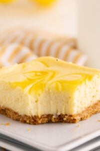 lemon cheesecake square with bite missing.