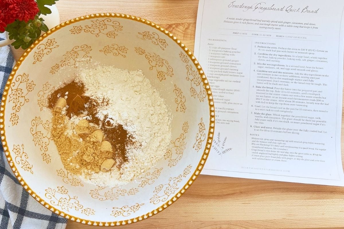 Flour, ground ginger, cinnamon, and brown sugar mounded in a decorative bowl beside the printed recipe.